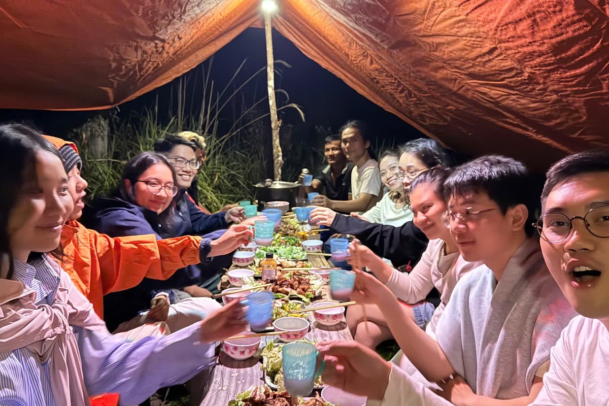 Bữa tối của cả đoàn dưới tấm bạt khu trại.